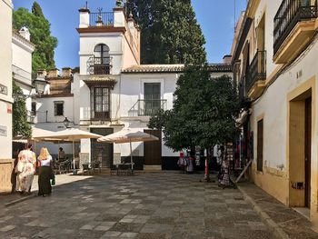 People on street amidst buildings in city