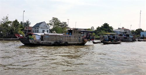 Boats in river with buildings in background