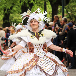 Portrait of happy woman dancing in traditional clothing during festival