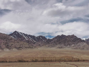Scenic view of landscape and mountains against sky