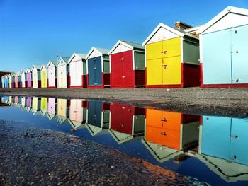 Colorful beach huts against sky