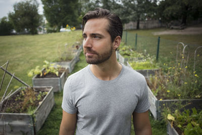 Thoughtful mid adult man in vegetable garden