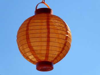 Low angle view of hot air balloon against clear blue sky