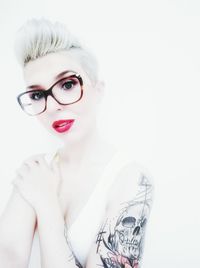 Portrait of young woman against white background