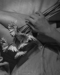 Close-up of woman hand on flowering plants