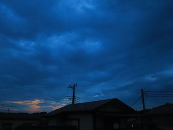 Low angle view of houses against sky at dusk