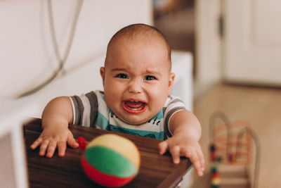 Portrait of cute baby boy at home