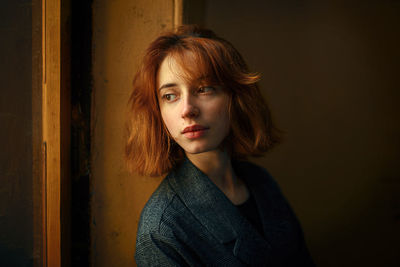 Portrait of woman against wall