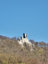 Low angle view of building against clear blue sky