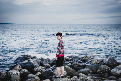 Rear view of man standing on beach