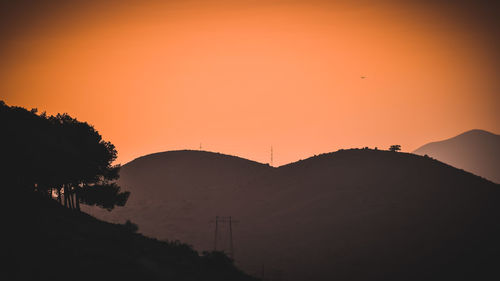 Scenic view of silhouette trees against orange sky