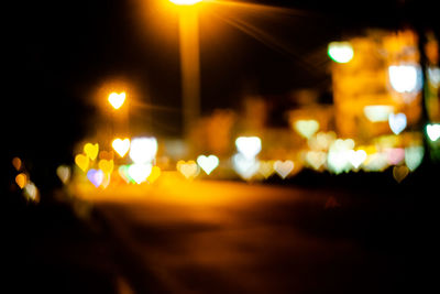 Defocused image of illuminated street lights at night