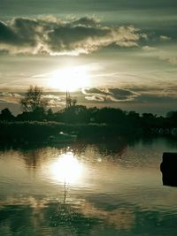 Scenic view of lake against sky during sunset