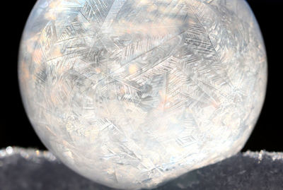 Close-up of bubbles over black background