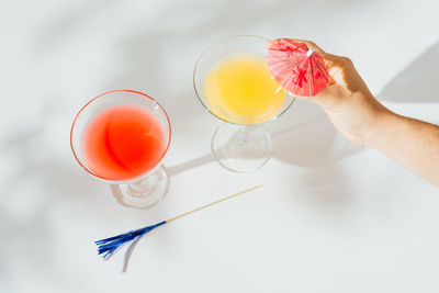 Alcoholic cocktails with marked shadows of the midday sun