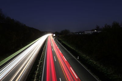 High angle view of light trails on highway at night