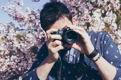 Portrait of woman photographing with camera
