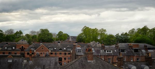 Buildings against cloudy sky