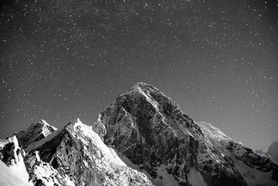 Majestic shot of snow capped mountains against clear sky