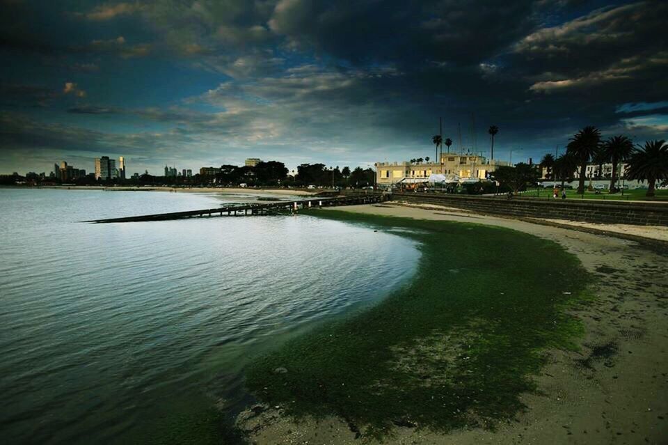 water, sky, building exterior, architecture, built structure, cloud - sky, cloudy, sea, city, waterfront, cloud, dusk, beach, nature, scenics, river, tranquility, tranquil scene, weather, beauty in nature