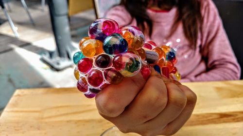 Midsection of woman holding multi colored decoration