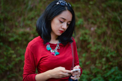 Close-up of mid adult woman using mobile phone