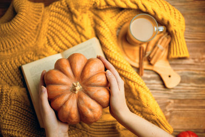 High angle view of person holding bread on table