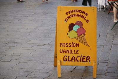 Sign board on footpath outside ice cream parlor