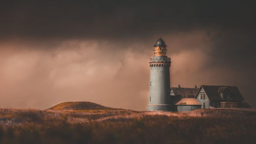 Low angle view of lighthouse against buildings