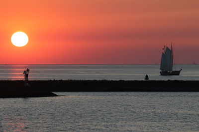 Scenic view of calm sea at sunset