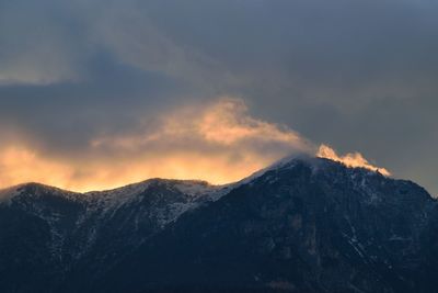 Scenic view of snowcapped mountains against sky during sunset