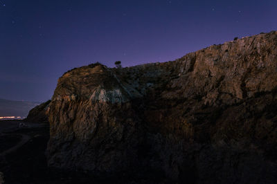 Scenic view of mountains against clear sky at night