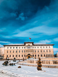 View of building against cloudy sky during winter