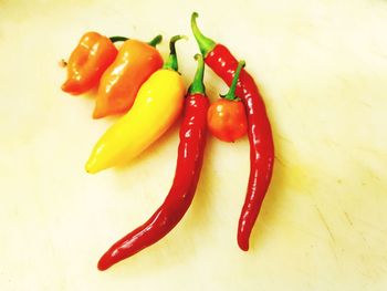 Close-up of red chili peppers on white background