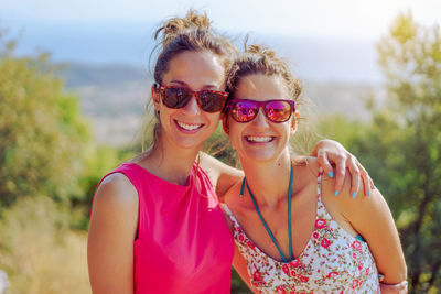 Portrait of smiling friends wearing sunglasses