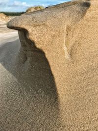 Close-up of shadow on sand at beach