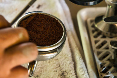 Close-up of hand holding coffee cup