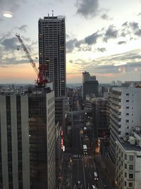 Skyscrapers in city at sunset