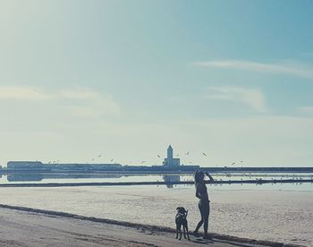 People at beach against sky