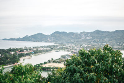 Panoramic shot of townscape by sea against sky