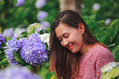 Close-up of woman with pink flower