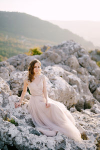 Woman sitting on rock