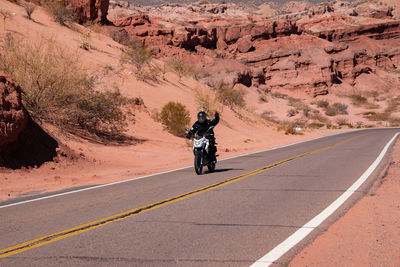 Man riding motorcycle on road