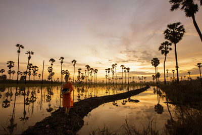 Scenic view of lake against sky during sunset