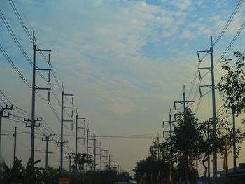 Low angle view of electricity pylon against sky