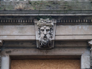 Low angle view of statue against building