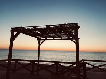 Scenic view of sea against clear sky during sunset