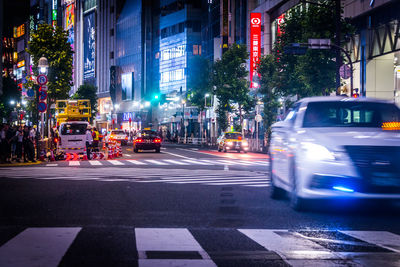 Cars on city street at night