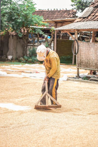 Man working while standing on land