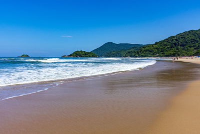 Paradise beach surrounded by rainforest and hills in bertioga on the coast of sao paulo